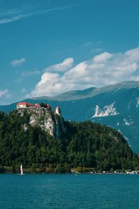 Scenic view of sea by buildings against sky