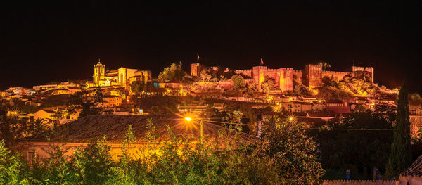 Illuminated buildings in city at night