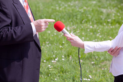 Close-up of man holding balloons