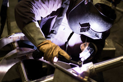 Man welding metal at factory