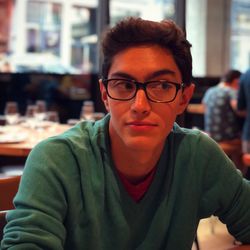 Portrait of young man sitting in restaurant