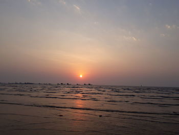 Scenic view of sea against sky at sunset