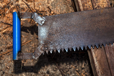 Old rusty hacksaw . manual wood cutting tool