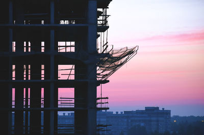 Low angle view of silhouette building against sky during sunset