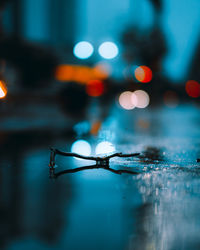 Close-up of wet illuminated lights in rainy season