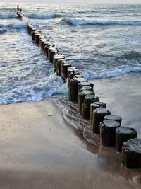 View of wooden posts in sea