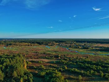 Scenic view of landscape against blue sky