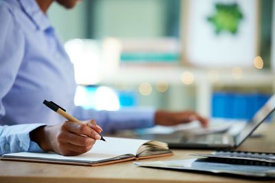 Midsection of man working on table