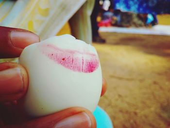 Close-up of hand holding ice cream