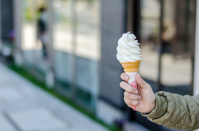 Hand holding ice cream cone