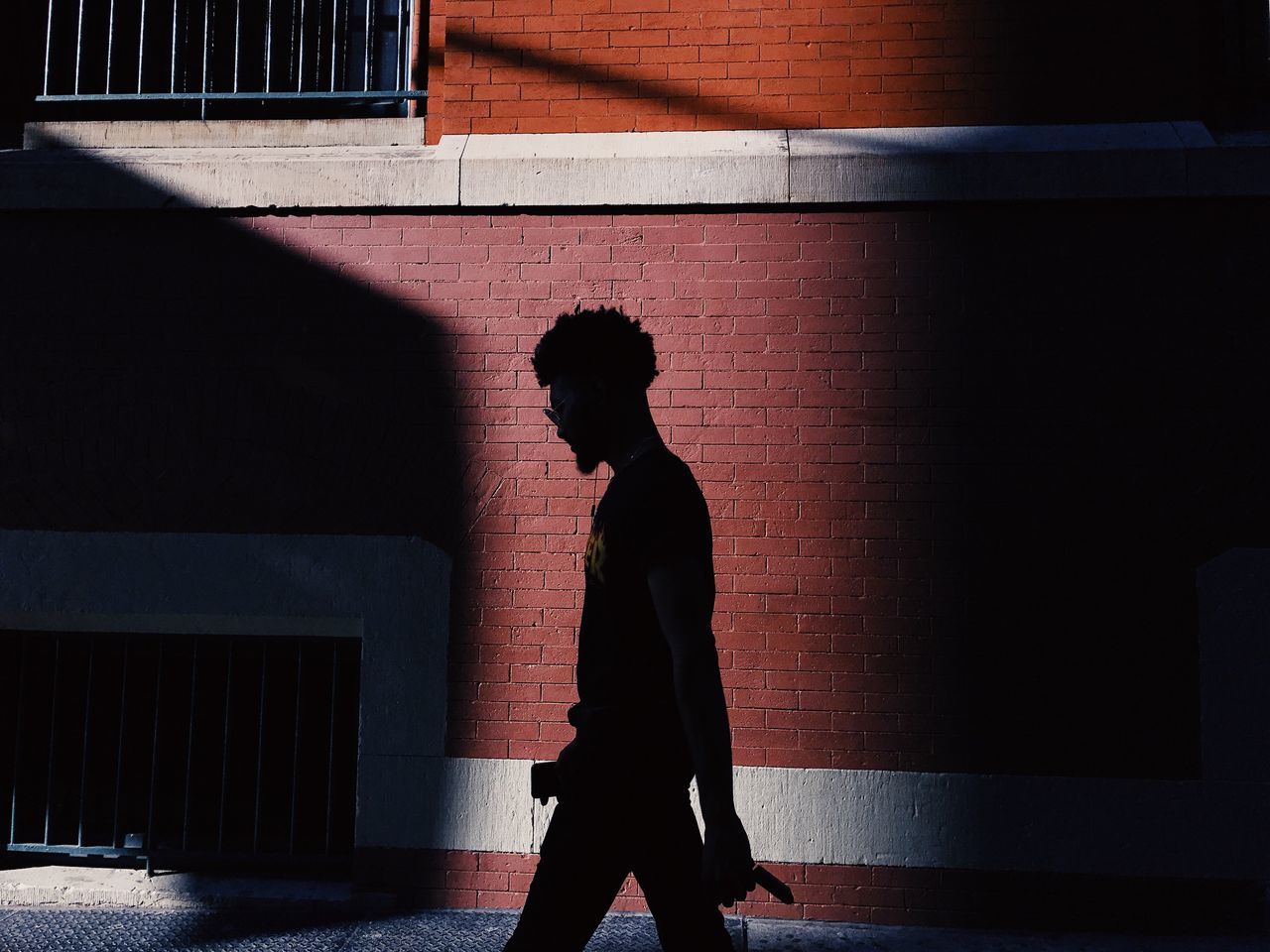 one person, shadow, built structure, real people, sunlight, lifestyles, architecture, standing, men, day, indoors, young adult, people