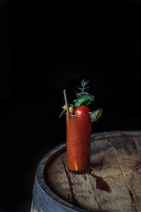 Bloody mary tomato brunch cocktail drink with celery, lemon, rosemary, pickles, olives, gold straw