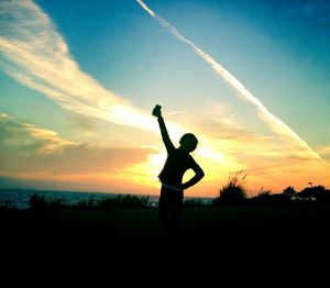 Silhouette of woman at sunset