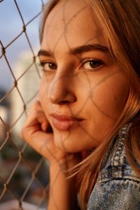 Close-up portrait of a young woman looking  at camera