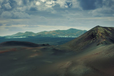 Scenic view of volcanic mountains against sky