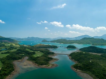 Scenic view of river amidst mountains against sky