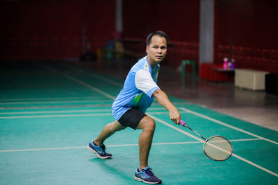 Young man playing with ball in the background