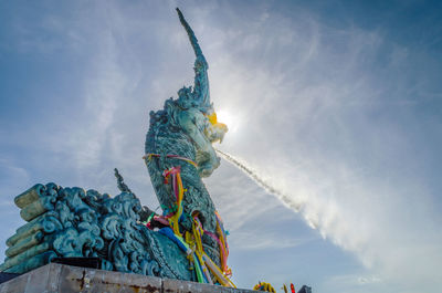 Low angle view of statue against sky