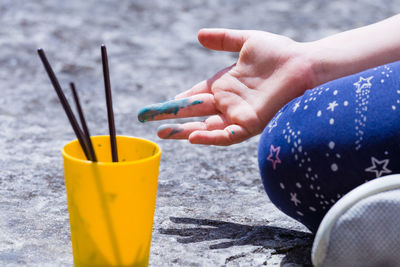 Close-up of hand holding yellow drink