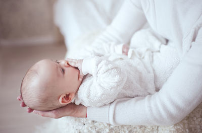 Midsection of mother and daughter at home