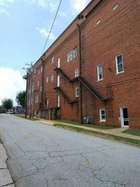 Empty road with buildings in background