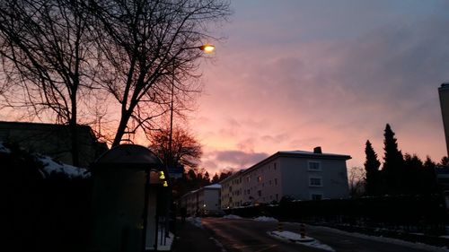 Cars on road at sunset