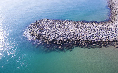 Aerial view of groynes at sea shore 