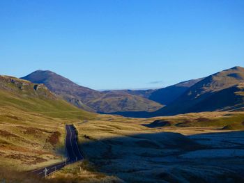 Scenic view of mountains against clear blue sky