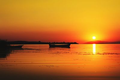 Scenic view of sea against orange sky during sunset