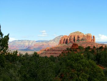 Scenic view of red mountains against clear blue sky