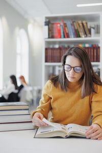 Young woman reading book