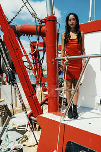 Low angle view of young woman standing in factory