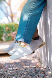 Low section of man wearing shoes