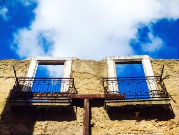 Low angle view of abandoned building against sky