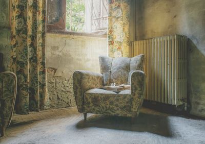 Empty chair in abandoned house