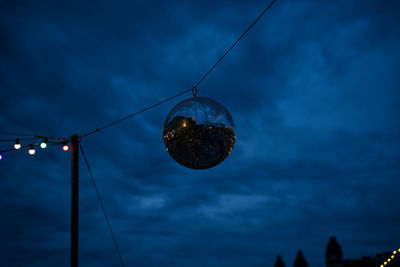 Disco ball in the cloudy sky