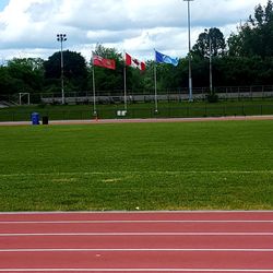 View of soccer field against cloudy sky