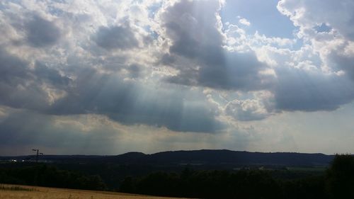 Scenic view of landscape against cloudy sky