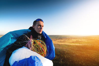 Guy holds the lines of a paraglider in his hands close-up. a male paraglider carries a paraglider to