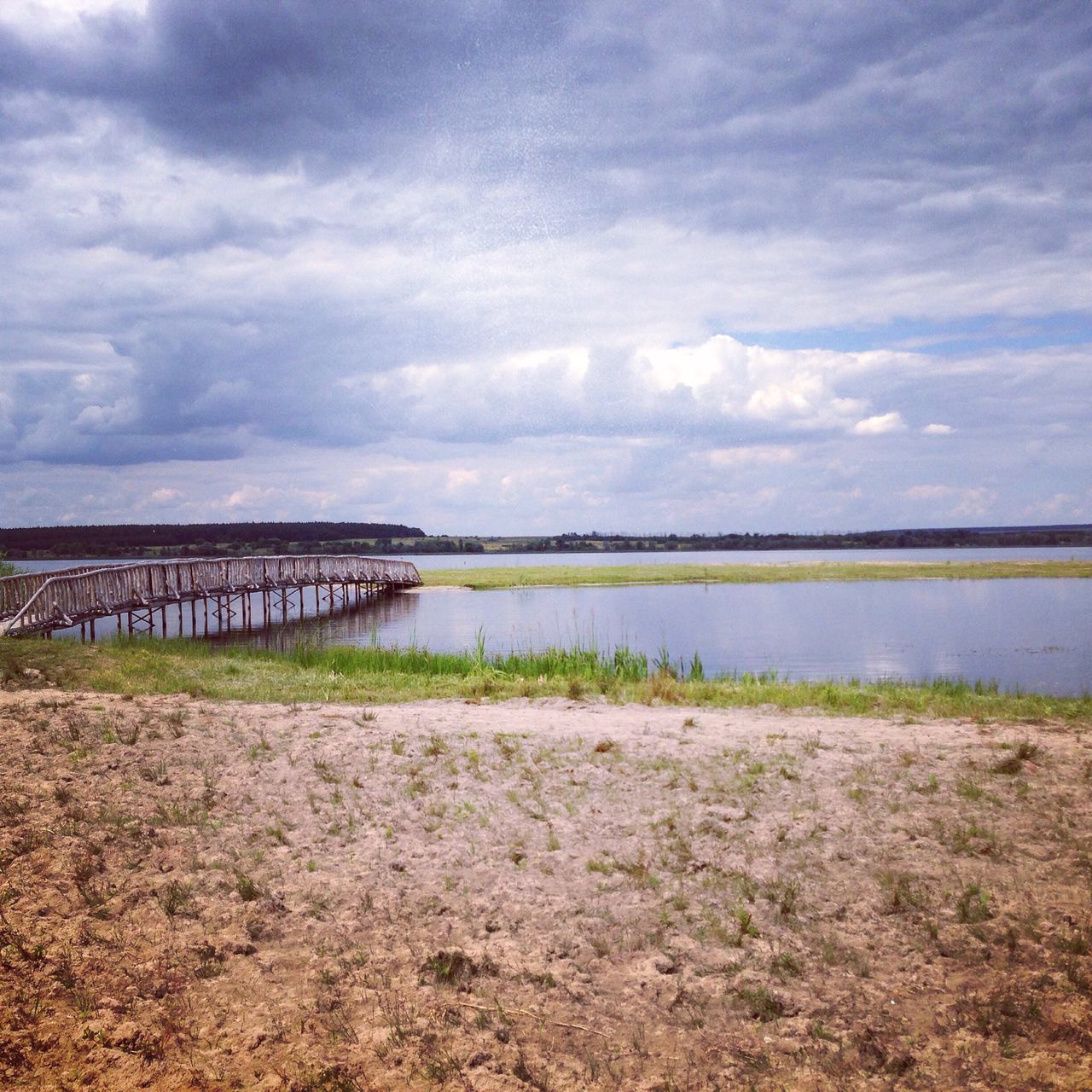 water, sky, cloud - sky, tranquil scene, tranquility, cloudy, lake, scenics, beauty in nature, nature, cloud, river, grass, idyllic, lakeshore, calm, reflection, day, non-urban scene, overcast