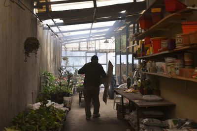 Rear view of man walking in corridor