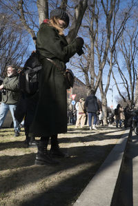 People walking on footpath in city