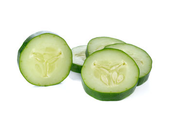 Close-up of green lemon against white background