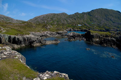 Scenic view of sea and mountains against sky