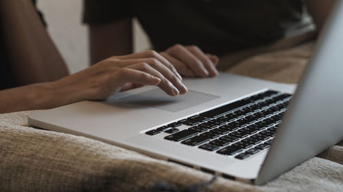 Midsection of woman using laptop