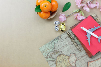 High angle view of oranges and map on table