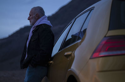 Rear view of man walking on car