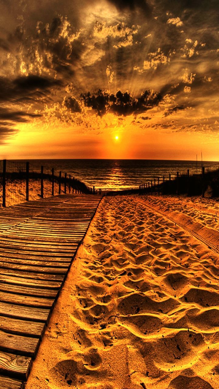 sunset, sea, water, horizon over water, beach, tranquil scene, scenics, tranquility, sky, beauty in nature, idyllic, pier, nature, shore, orange color, sand, cloud - sky, the way forward, sun, sunlight