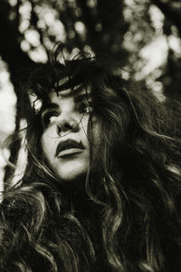 Close-up of woman looking away standing outdoors