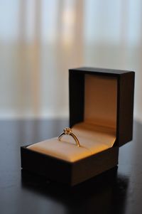 Close-up of ring in box on table